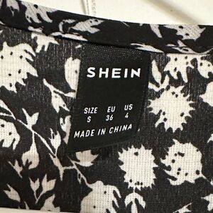 Black and white dress, ankle length, shorter in the front, tie around waist